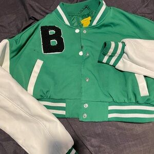 Green with leather white sleeves. Super cute varsity jacket